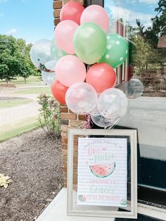 a watermelon themed birthday party with balloons and a sign on the front door