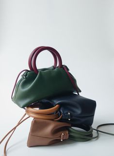 Introducing 'The Fawn' collection: Compact, lightweight, yet spacious with two contrasting colors for a unique character.  Ideal for those who seek style without bulk, it offers a minimalist solution for essentials. Crafted with Full-grain Italian Aniline leather, the finest grade of hides, ensuring durability. Aniline leather is renowned for its exceptional natural touch, distinctive patterns in each piece, and can develop a beautiful shine over time with use.  Specially designed hardware accents adorn both sides of the bag, enhancing its appeal with a blend of attractiveness, playfulness, and sophistication. The Fawn is versatile in its usage. It can be carried by the top handles, on the arm, over the shoulder, or as a crossbody, offering convenience for all your daily activities Each ba Satchel Box Bag With Handle Drop For Errands, Minimalist Satchel Bag With Detachable Strap, Minimalist Satchel With Detachable Handle For Daily Use, Minimalist Bag With Detachable Double Handle, Modern Box Bag With Handles For Everyday, Minimalist Top Handle Box Bag For Daily Use, Modern Green Pouch Box Bag, Modern Everyday Box Bag With Handles, Minimalist Top Handle Satchel For On-the-go