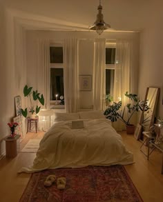 a bedroom with a large bed and lots of plants