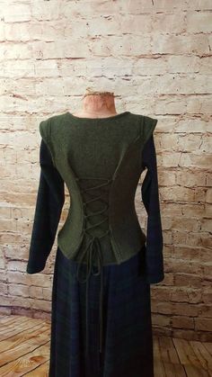 I make this comfortably warm bodice from a beautiful, dark olive-colored, melange wool walk. The wool walk is a knitted fabric and therefore elastic. It is made of 100% virgin wool. The bodice can be easily adjusted to the size and preferred wearing comfort thanks to the lacing in the back. Size S Chest circumference: approx. 77-90 cm 2`6"-2`11" Waist circumference: approx. 64-80 cm 2`1"-2`7" Hip circumference: approx. 89-106 cm 2`11"-3`6" Neckline: approx. 21 cm 0`8" Lacing: approx. 13 cm 0`5" Medieval Bodice, Irish Dress, Vest Pattern, Wool Vest, Boiled Wool, Green Wool, Olive Color, Role Play, Doll Clothes Patterns