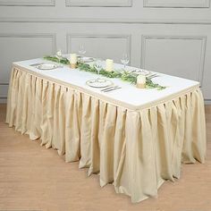 the table is set with candles and place settings for two people to sit at it