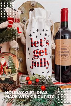 a bottle of wine sitting on top of a table next to christmas decorations and other items