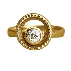 a gold ring with a diamond in the center