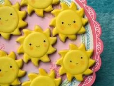 there are many yellow sun cookies on the plate