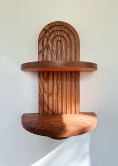 a wooden shelf with two shelves on each side and a circular object in the middle