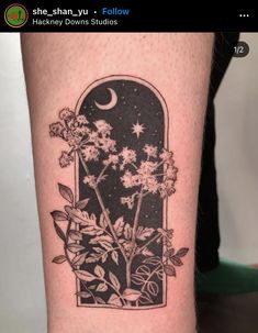 a black and white photo of flowers on the leg with a moon in the background