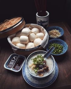 there are many different foods in bowls on the table, including rice and meatballs