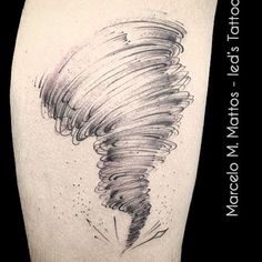 a black and white photo of a tornado tattoo on the right thigh with words written below it