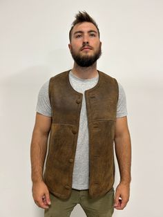 Perfect for three seasons, with the choice to layer on cooler days. Our sheepskin vest are durable, stylish and 100% natural allowing for your body to regulate warm in a productive way. Do you hate how body heat feels from polyester or synthetic fabrics? Then natural sheepskin and wool is the right choice for you. Our vest are made from Merino shearling sheepskin that hasn’t been treated with chemicals that are harmful to the skin. _____ Rugged Leather Vest Outerwear, Rugged Brown Vest Outerwear, Rugged Fitted Vest Outerwear, Fitted Sleeveless Rugged Outerwear, Rugged Brown Winter Vest, Brown Rugged Vest For Winter, Brown Rugged Winter Vest, Classic Brown Outdoor Vest, Classic Brown Vest For Outdoor