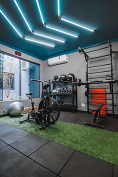 an indoor gym with exercise equipment and neon lights