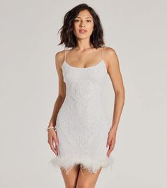 The Adelina sequin mini dress makes an entrance whether you're a bride-to-be or a birthday girlie! The formal party dress is designed with a sleek scoop neckline, a flattering bodycon silhouette, and a fabulous marabou feather trim along the hem. Pair with a rhinestone bracelet.Fit & FeaturesSheer mesh fabric with knit lining, moderate stretchSequin embroidered scroll patternScoop necklineBungee spaghetti straps, back zipper closureMini-length hem with marabou feather trimBodycon silhouetteR Fitted Lace Mini Dress With Sequins, Fitted Lace Dress With Feather Trim, Elegant Fitted Sequin Dress With Feather Trim, Bridal Era, White Holiday Dress, Era Outfits, Orange Homecoming Dresses, Sequin Holiday Dress, Purple Homecoming Dress