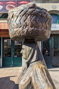 a statue with a large piece of bread on it's head