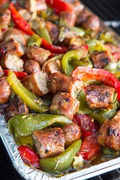 sausage, peppers and onions in a pan with text overlay that reads italian sausage, peppers and onions