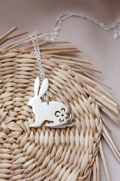 Lola&Cash loves bunnies, you may have noticed ❤ -- d e t a i l s -- -rabbit pendant measures 2.5cm tall -hand sawn from sterling silver, with a pretty floral design hand pierced on the bunny's body -completed in a mirror finish -includes a 45cm silver chain -All Lola&Cash jewellery will arrive in gift giving mode -------------------------------- Please Note - Made to order I require up to 2 weeks for manufacturing jewellery orders & send out email notifications once your order has be Easter Bunny Design Jewelry Gift, Silver Bunny Design Jewelry For Gifts, Silver Bunny Design Jewelry Gift, Silver Jewelry With Bunny Design For Gift, Rabbit Necklace, Rabbit Jewelry, Hand Piercing, Bunny Necklace, Rabbit Pendant