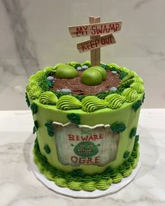 there is a green cake with a sign on it