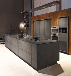 a modern kitchen with stainless steel appliances and cabinets