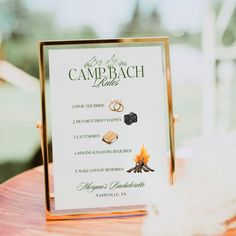 a sign that is sitting on top of a table with some rings and other items