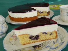 two pieces of cake sitting on plates next to a cup and saucer with a fork