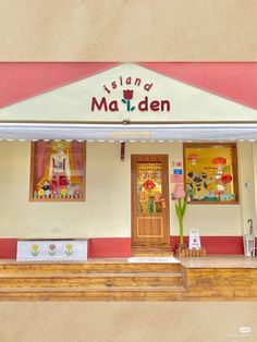 a store front with an awning over the door and steps leading up to it