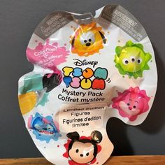 the mickey mouse mystery pack is in its package with other disney character figures on it