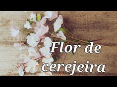 the words flor de cerejeira are written in white and pink flowers