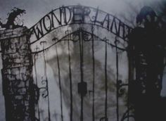 a black and white photo of an iron gate with the word wonderland on it