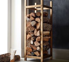 a stack of logs sitting next to a pile of wood on top of a floor