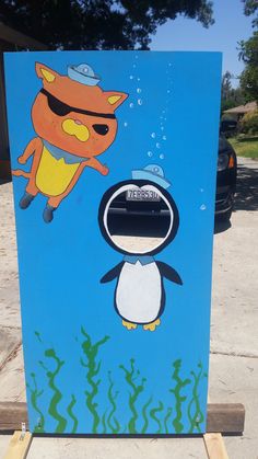 a blue refrigerator with an image of a cartoon character and a penguin on it's side