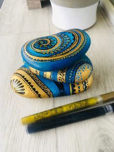 a pen and some rocks on a table