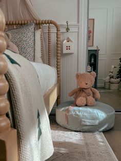 a teddy bear sitting on top of a round bed