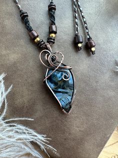 Embrace the mystical energy of Pietersite with this handmade pendant in antiqued copper. This bohemian necklace features a macrame detail for a unique touch. Perfect for those who love artisan jewelry. This pendant is wire wrapped and hand woven in solid copper with a Pietersite Cabochon and then oxidized and hand polished to give that antiqued look. ★★Material and size★★ Pendant size approx :  54x24mm (Pietersite approx 31x21mm) Waxed Polyester threads, wood bead , brass bead, coconut shell bea Bohemian Brown Electroformed Necklaces, Handmade Bohemian Copper Wire Jewelry, Earthy Copper Jewelry For Festivals, Bohemian Hand Forged Adjustable Necklaces, Bohemian Brown Necklace With Copper Wire, Bohemian Adjustable Hand Forged Necklaces, Earthy Wire Wrapped Jewelry For Festivals, Adjustable Bohemian Hand Forged Necklaces, Bohemian Brown Copper Wire Jewelry