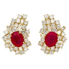 Vintage Ruby and Diamond Earrings in 18K Yellow Gold. These earrings each feature an oval-cut red ruby center stone, totaling 4.50 carats in weight. The ruby is paired with a decorative array multi-cut diamonds, including baguette and round, for a total weight of 2.0 carats. The stones are secured in a prong setting, and the earring closure is a comfortable leverback. With a weight of 14 grams, these earrings are a true investment in luxury and create an elegant addition for any occasion. Item D 1960s Earrings, Ruby And Diamond Earrings, Chanel Flower, Violet Earrings, Grape Earrings, Starburst Earrings, Gold Pearl Earrings, Long Dangle Earrings, Knot Earrings