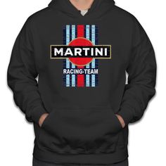 a man wearing a black hoodie with the words martini racing team printed on it