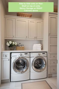 a washer and dryer in a small room with white cabinets on the wall