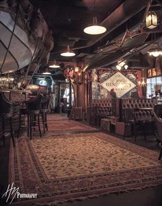 a large area rug in the middle of a room with tables and chairs around it