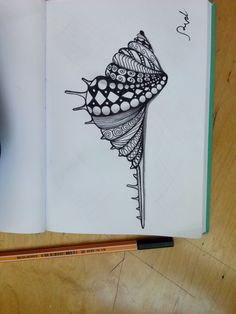 an open notebook with a drawing of a flower