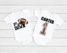 two personalized onesuits with the number one and football on them