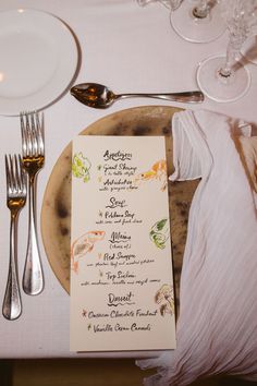 a table setting with silverware and menus