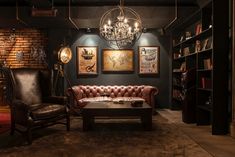 a living room filled with lots of furniture next to a fire place and bookshelf