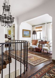 a living room filled with furniture and a chandelier