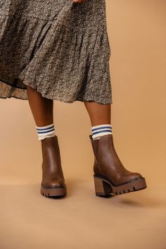 The Rusty is a dark brown bootie featuring a 3" heel and a small platform. Take inspo from our pictures and pair with your favorite boot socks and a floral dress! 3 1/4" heel; 1/2" platform 9 1/4" shaft; 10 1/2" calf circumference Contoured footbed Synthetic upper and lining/rubber sole *FINAL SALE* Favorite Boots, Brown Booties, Skirt Jumpsuit, Resort Collection, Plus Size Shopping, Boot Socks, Swimsuit Cover, Sweatshirt Dress