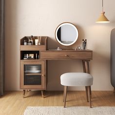 a wooden desk with a mirror, stool and other items on the table in front of it