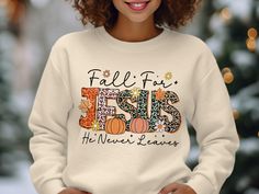 Celebrate your faith and the autumn season with this "Fall for Jesus He Never Leaves" graphic tee. Perfect for any Christian looking to combine their love of fall with their devotion to Jesus, this inspirational t-shirt features a vibrant design with pumpkins and fall leaves. A perfect addition to your fall wardrobe or a thoughtful gift for friends and family who cherish their faith. Product Features: Fabrication: Medium-heavy fabric (8.0 oz/yd² (271.25 g/m 50% cotton, 50% polyester Seams: Witho Fall For Jesus, Jesus Shirt, Christian Sweatshirt, Faith Shirt, Christian Shirt, Jesus Shirts, Christian Inspiration, Vibrant Design, Fall Leaves