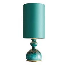 a blue lamp with a green shade on it's base and a white background