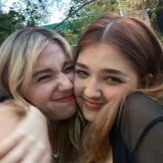 two young women hugging each other and smiling