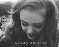 black and white photograph of a woman with long hair looking down at her cell phone