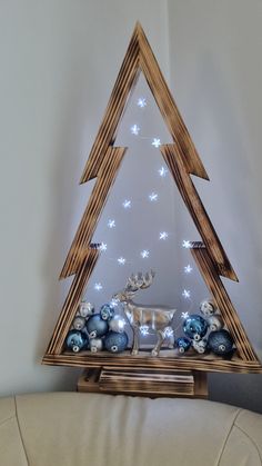 a wooden christmas tree with blue and white ornaments