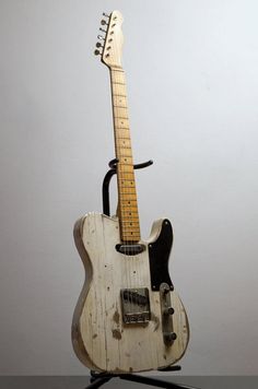 an old white guitar is on display