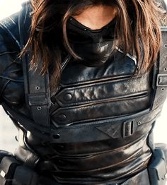 a woman in black leather outfit and goggles