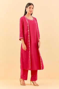 Hot pink three fourth sleeves A-line kurta with floral sequins, beads, nalki embroidered attached long jacket in chanderi cotton base. Paired with matching pant.
Components: 2
Pattern: Embroidery
Type Of Work: Sequin, Beads
Neckline: Round
Sleeve Type: Three Fourth
Fabric: Chanderi Cotton, Cotton Silk
Color: Pink
Other Details: 
Attached inner lining
Model Height: 5ft 6inches, wearing size L
Occasion: Sangeet, Mehendi and Haldi - Aza Fashions Spring Salwar Kameez With Mirror Work And Long Sleeves, Spring Long Sleeve Salwar Kameez With Mirror Work, Spring Anarkali Set With Mirror Work And Straight Kurta, Pink Nehru Jacket For Festive Occasions, Spring Salwar Kameez With Gota Work And Long Sleeves, Festive Pink Chanderi Nehru Jacket, Spring Festive Nehru Jacket With Gota Work, Spring Long Sleeve Salwar Kameez With Gota Work, Spring Long Sleeve Kurta With Gota Work